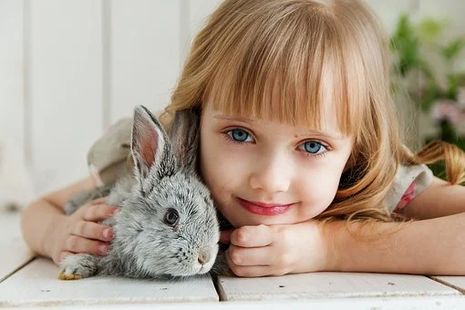 A kid with a rabbit.